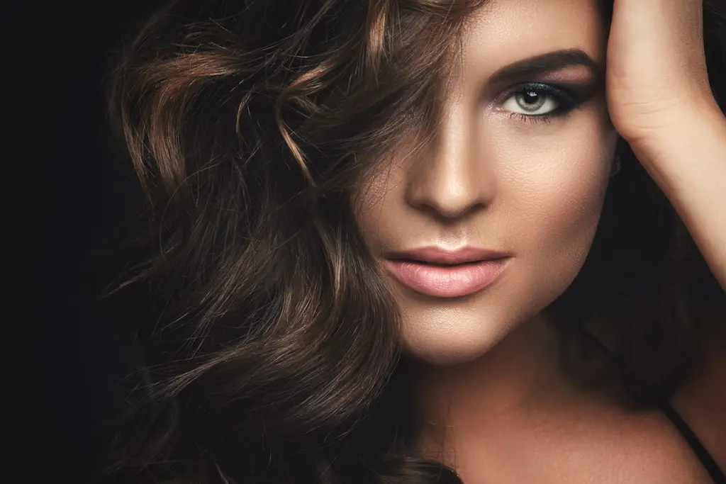 Woman with curly hair and glowing skin, contact Dulwich Natural Beauty London