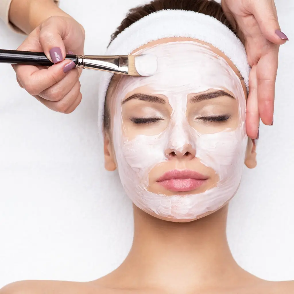 Woman receiving a facial mask treatment, aesthetic skin treatments at Dulwich Natural Beauty London