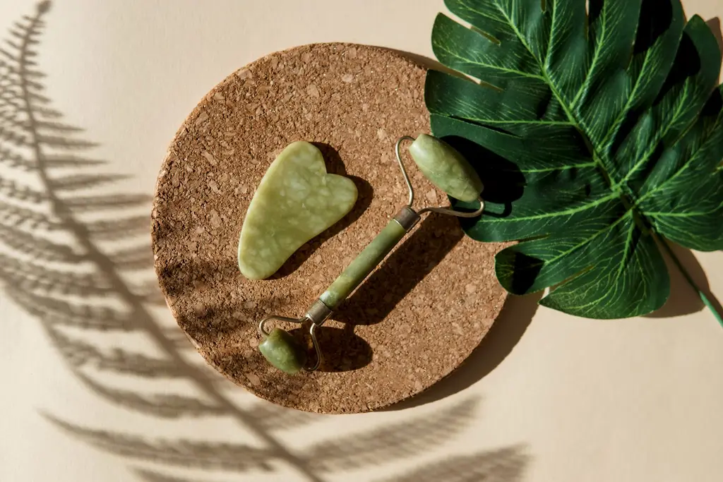 Jade gua sha and facial roller on a cork tray, eDS skin revitalisation at Dulwich Natural Beauty London