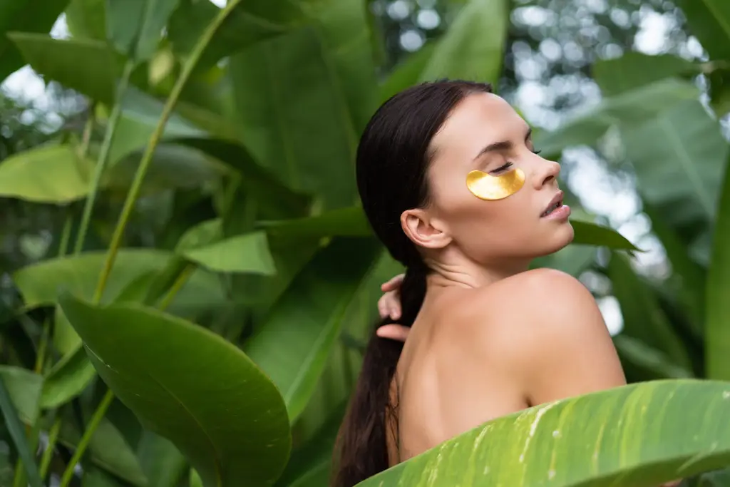 Woman with healthy natural skin framed by green leaves, Dulwich Natural Beauty London