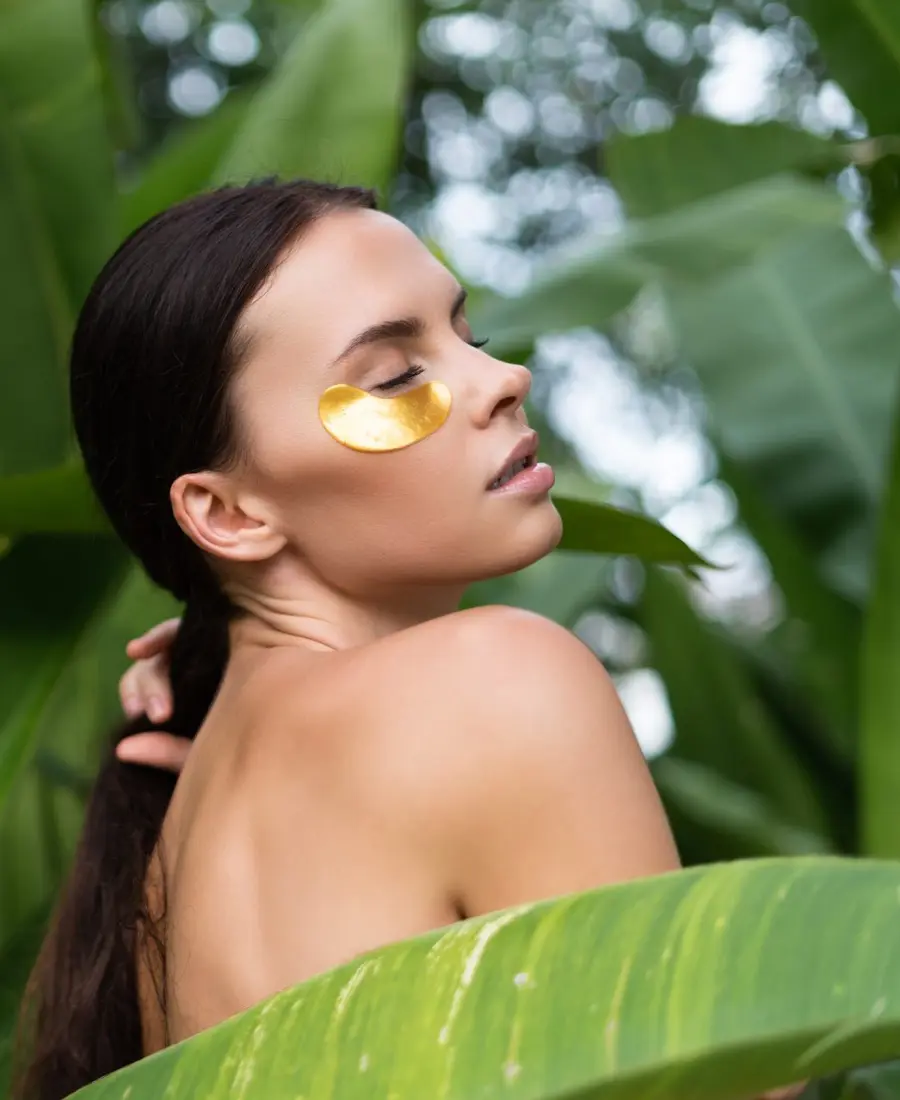 Woman with healthy natural skin among green leaves, qualified aesthetic nurse care at Dulwich Natural Beauty