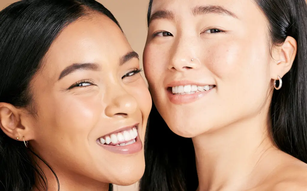 Two smiling women with healthy glowing skin, client reviews for Dulwich Natural Beauty London